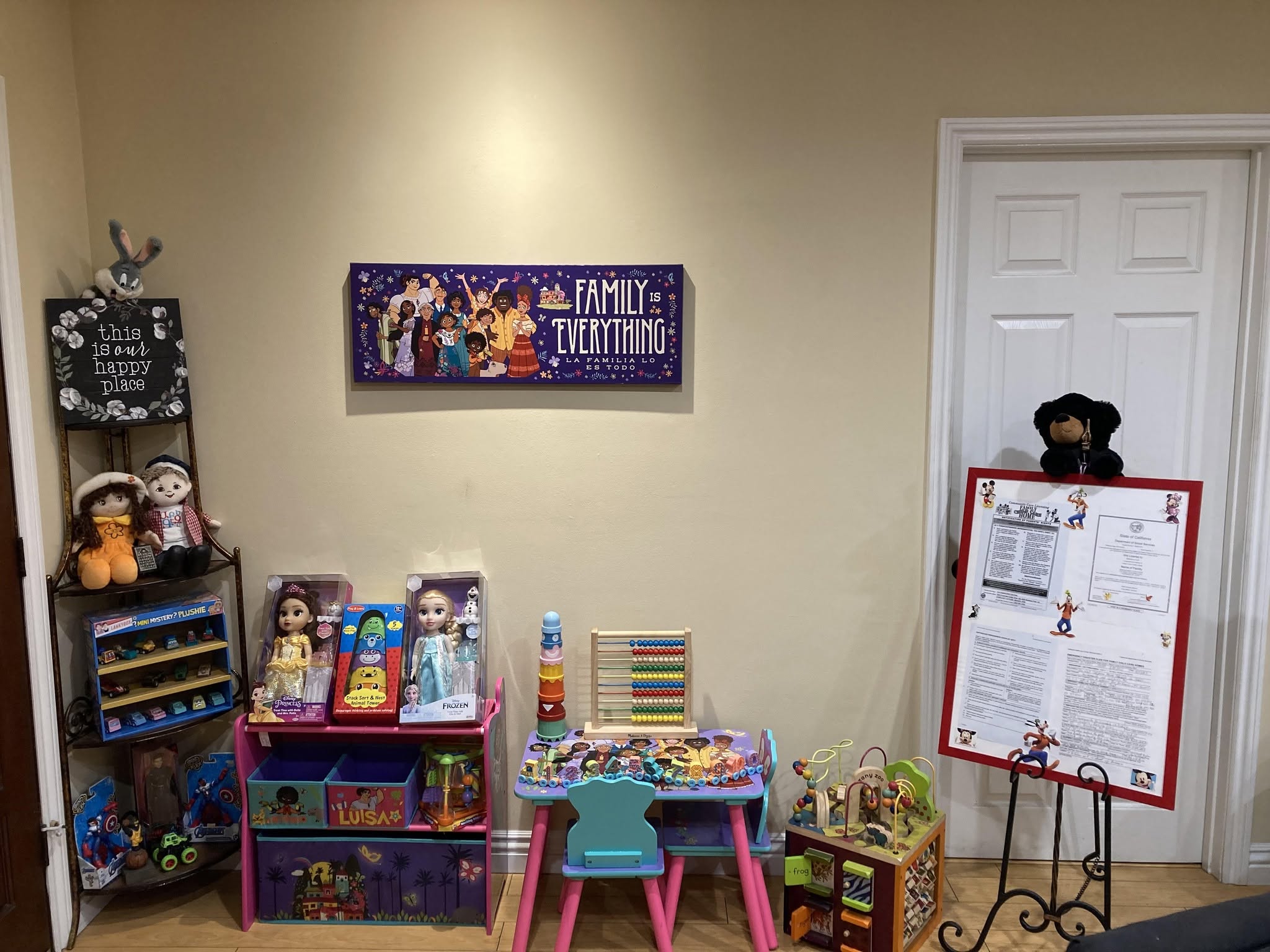 Indoor learning corner at Tiny Treasures with an activity table, materials, and displayed certificates